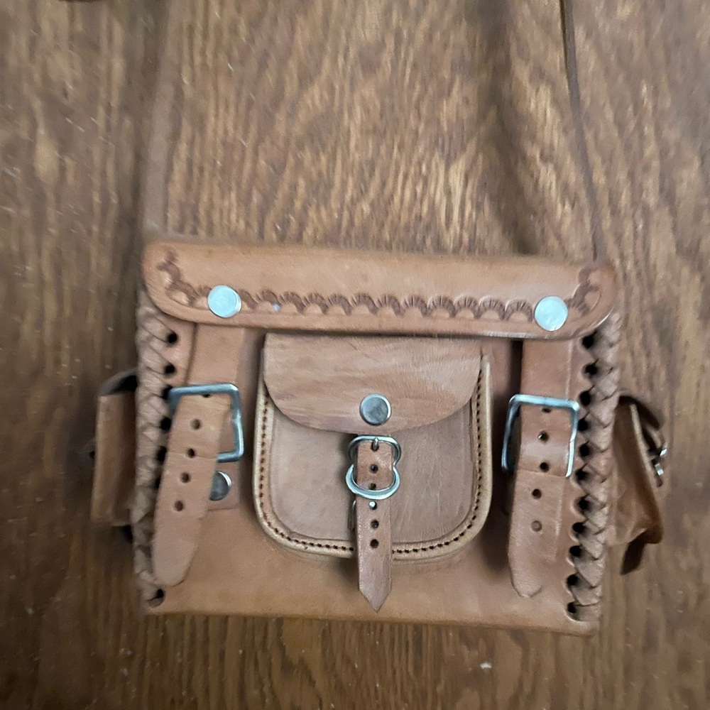Raw leather tooled purse